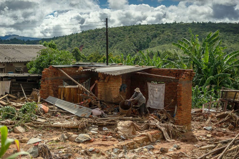 PHOTO: A man cleans up a destroyed house, March 19, 2019, in Chimanimani, Zimbabwe, as a hundred houses were damaged by the Cyclone Idai.