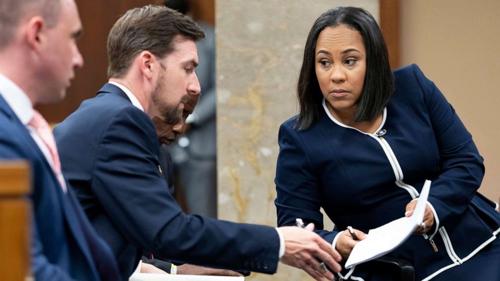 PHOTO: FILE - Fulton County District Attorney Fani Willis, talks with a member of her team in Fulton County, Ga., May 2, 2022.