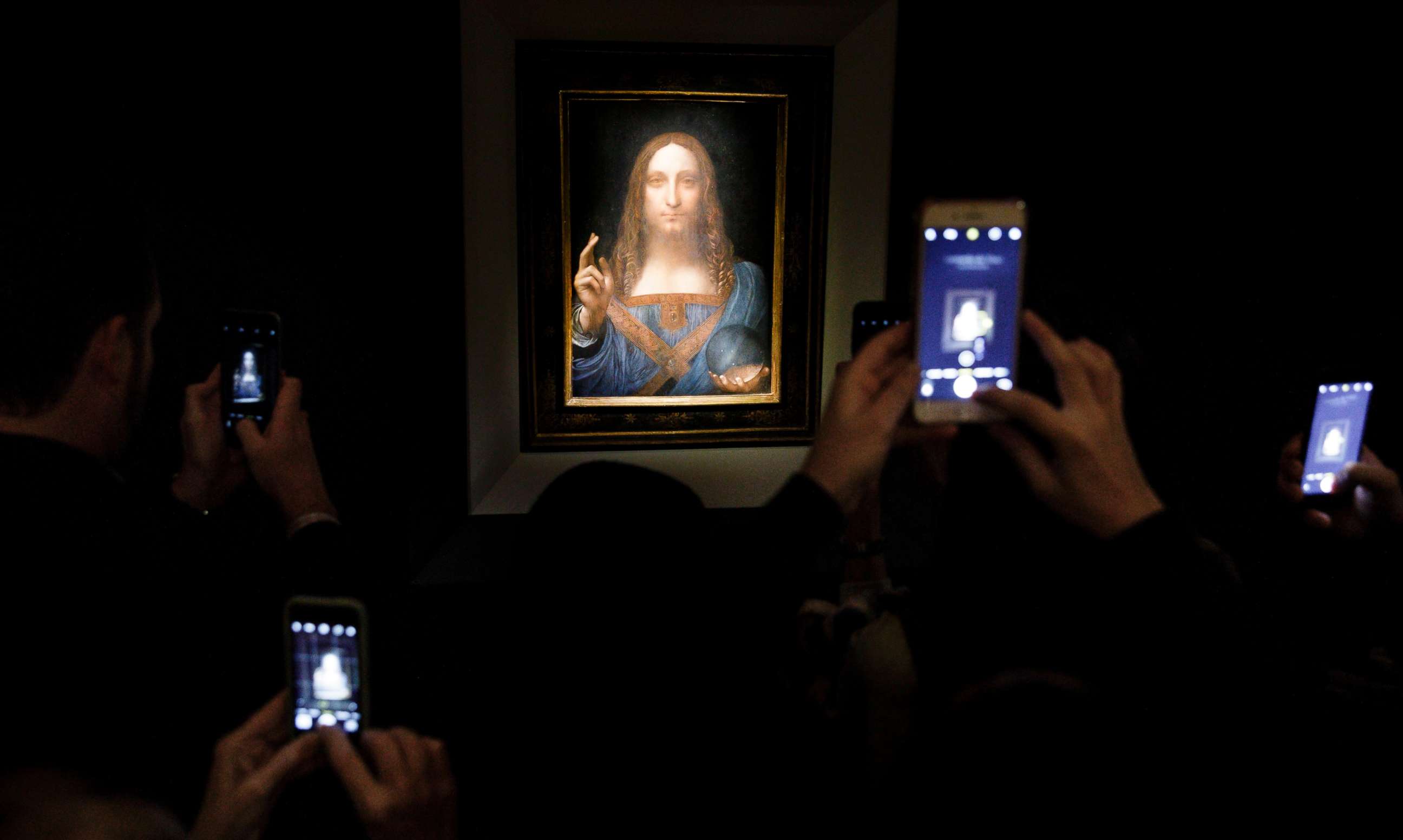 PHOTO: People take pictures of the painting 'Salvator Mundi' by Leonardo da Vinci (circa 1500) during a public preview before an auctioning of the painting tonight at Christie's auction house in New York, Nov. 15, 2017. 