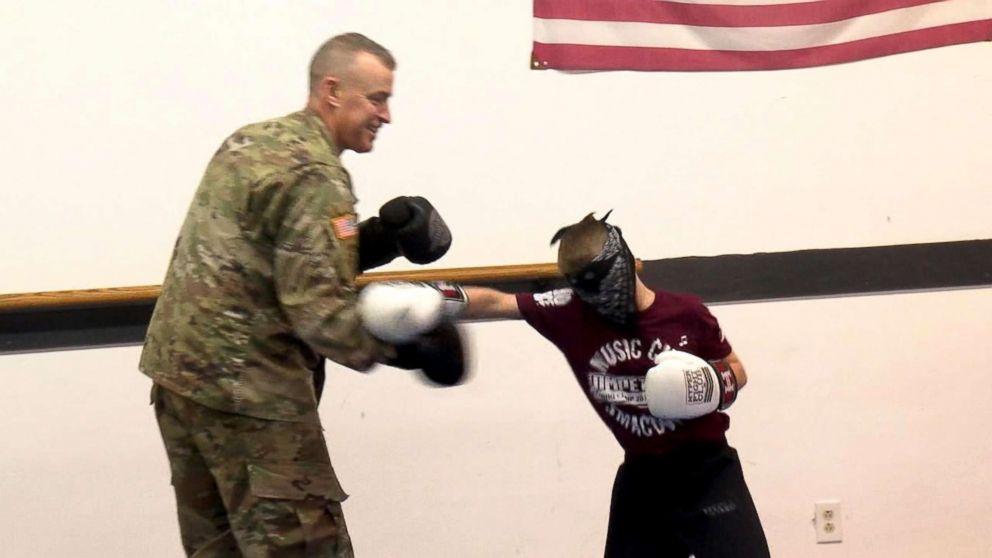 PHOTO: Army Staff Sgt. Ron Cesternino spars with his son at his taekwondo class during surprise homecoming.