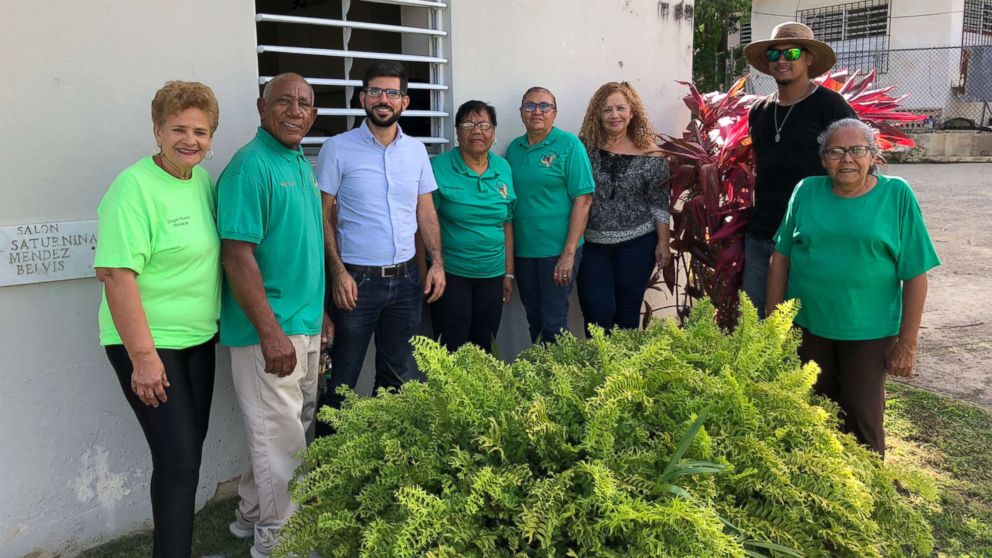 Members of the Social and Cultural Development Committee of Daguao stand alongside a member of the Resilient Power Puerto Rico team.