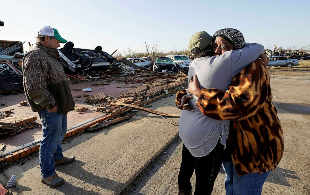 PHOTO: Tracy Hardin, center, who with her husband Tim, at left, own Chuck's Dairy Bar, consoles a neighbor in Rolling Fork, Miss., March 25, 2023.