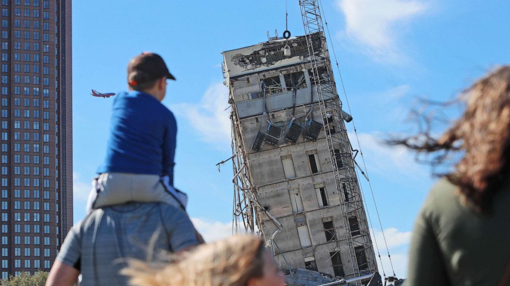 An implosion, meant to bring down an 11-story structure, left a tower at the center of the building still standing.