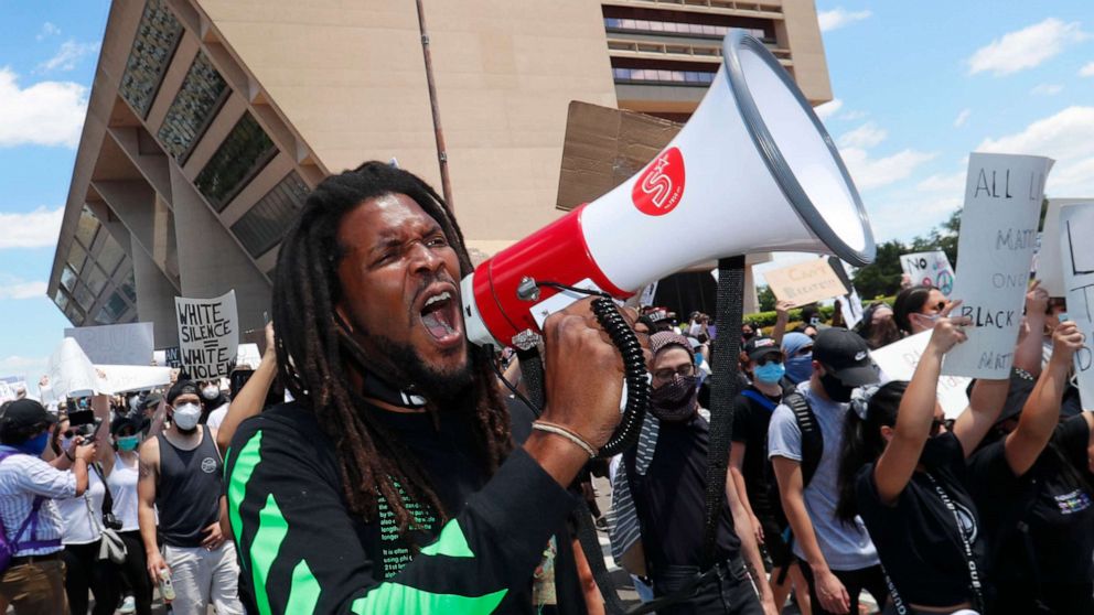 PHOTO: In this May 30, 2020, file photo, protesters chant in front of Dallas City Hall in downtown Dallas.