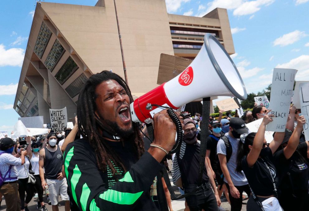PHOTO: Protesters chant in front of Dallas City Hall in downtown Dallas, Saturday, May 30, 2020. Protests across the country have escalated over the death of George Floyd who died after being restrained by Minneapolis police officers on Memorial Day.