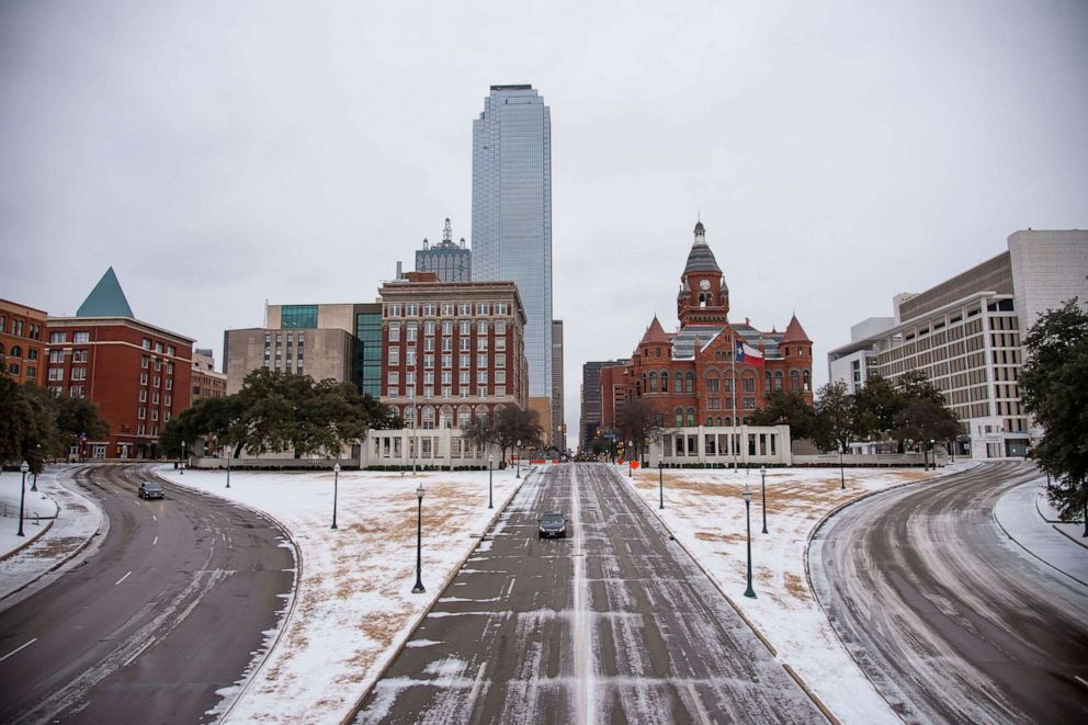 PHOTO: Cars drive through downtown after a winter storm on Feb. 3, 2022 in Dallas.