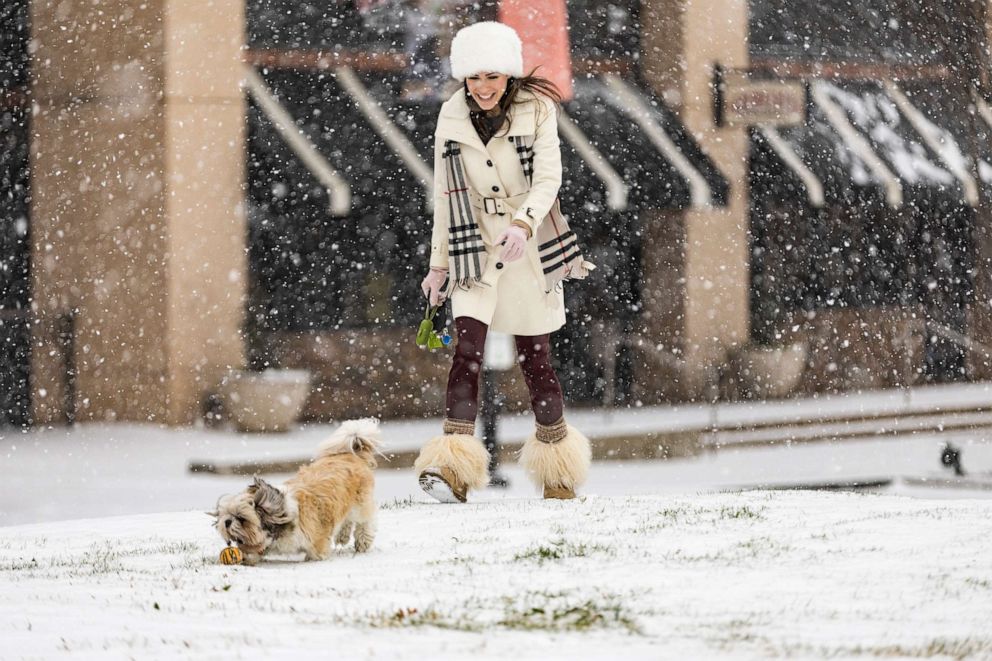 PHOTO: Misty Huckabey ventures out with her dog, Buddha, to play fetch at The Shops at Park Lane, Feb. 3, 2022, in Dallas.