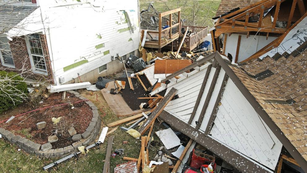PHOTO: Debris lies around a damaged house the morning after a tornado touched down in Florissant, Missouri, March 15, 2025.