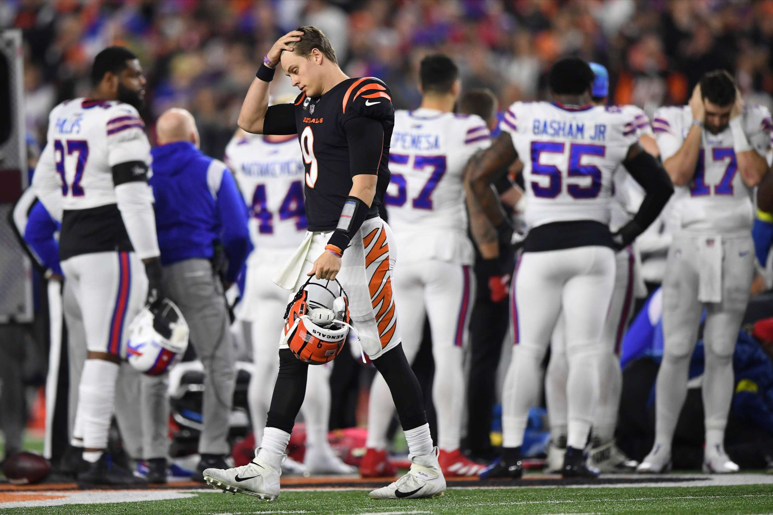 PHOTO: Cincinnati Bengals quarterback Joe Burrow pauses as Buffalo Bills' Damar Hamlin is examined by medical staff during the first half of an NFL football game, Jan. 2, 2023, in Cincinnati.