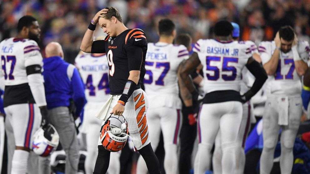 PHOTO: Cincinnati Bengals quarterback Joe Burrow pauses as Buffalo Bills' Damar Hamlin is examined by medical staff during the first half of an NFL football game, Jan. 2, 2023, in Cincinnati.