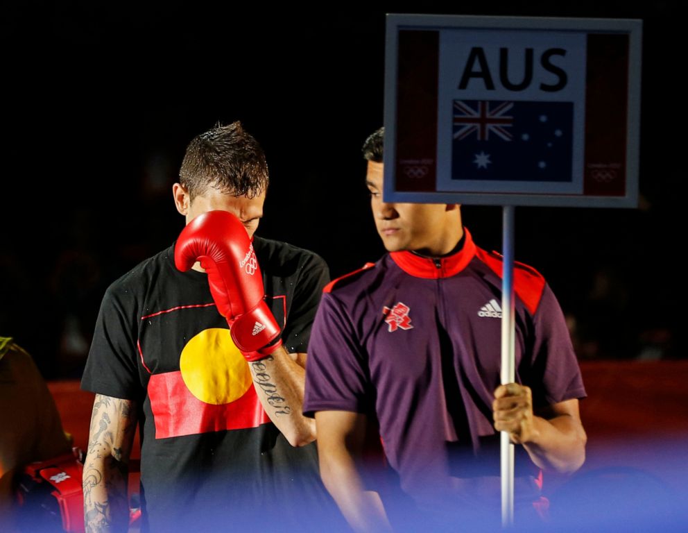 PHOTO: In this July 30, 2021, file photo, Australian Damien Hooper walks to the ring wearing a t-shirt with the Aboriginal flag for his boxing match during the London 2012 Olympic Games.