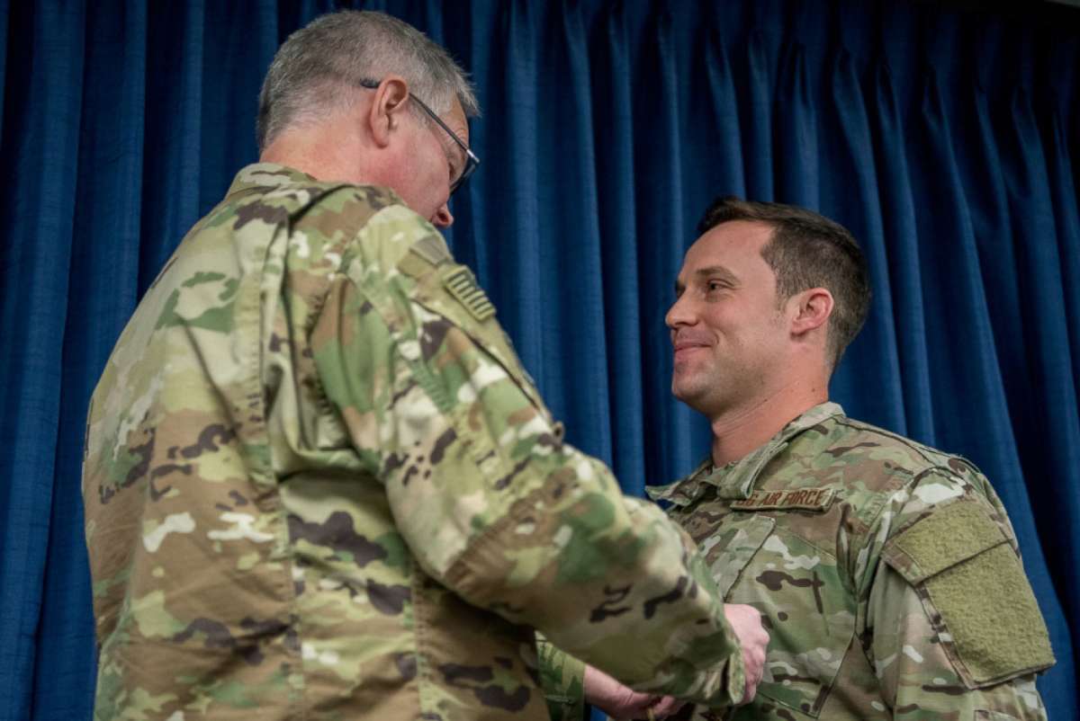 PHOTO: Staff Sgt. Daniel P. Keller (right), receives the Bronze Star Medal from Col. David Mounkes, commander of the 123rd Airlift Wing, at the Kentucky Air National Guard Base in Louisville, Ky., Nov. 17, 2018.