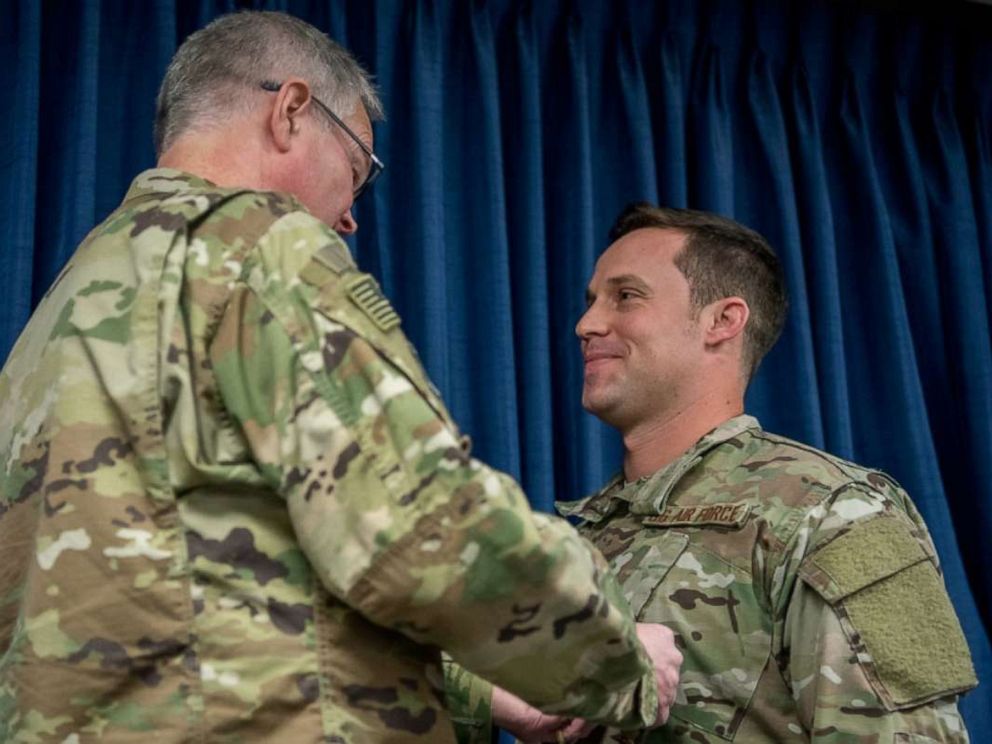 PHOTO: Staff Sgt. Daniel P. Keller (right), receives the Bronze Star Medal from Col. David Mounkes, commander of the 123rd Airlift Wing, at the Kentucky Air National Guard Base in Louisville, Ky., Nov. 17, 2018.