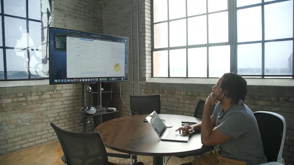 PHOTO: Darren examines the data from JustAir's ten sensors that are placed throughout Grand Rapids.