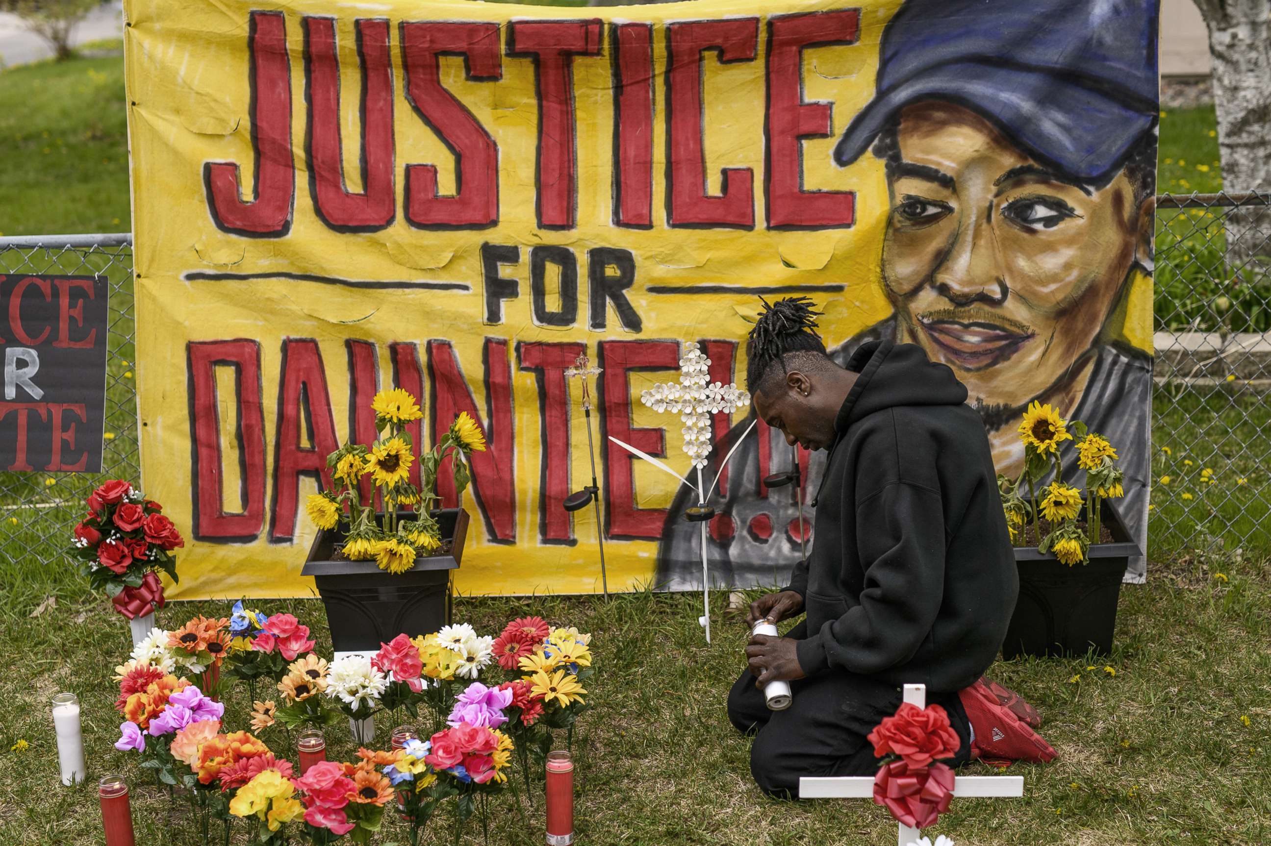 PHOTO: Antwon Davis lights candles at a memorial for Daunte Wright, May 2, 2021, in Brooklyn Center, Minn.