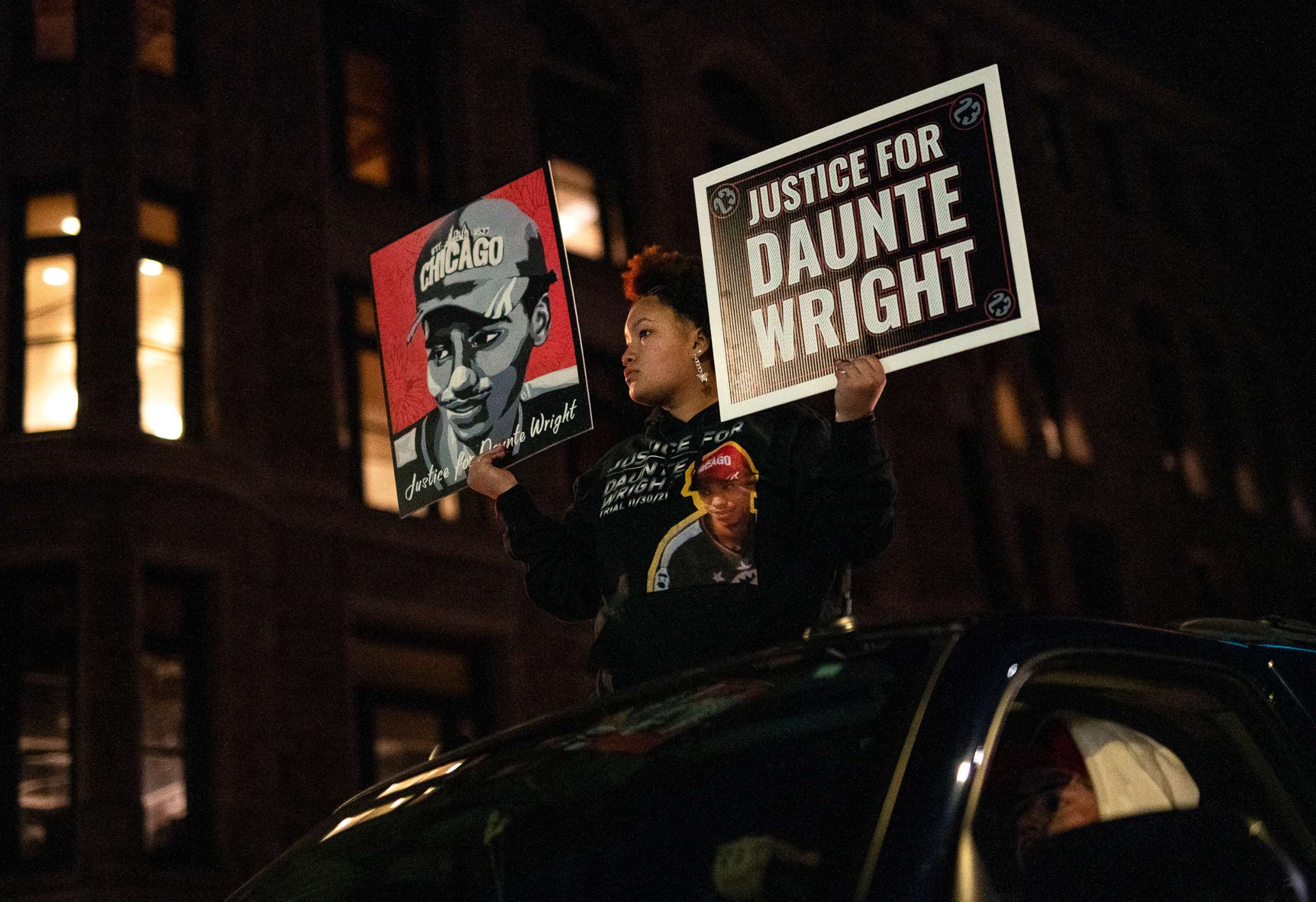 PHOTO: Diamond Wright, the sister of Daunte Wright, holds signs during a demonstration march on Nov. 30, 2021, in Minneapolis, as jury selection began in the trial of former officer Kim Potter, who is charged in the shooting death of Wright. 