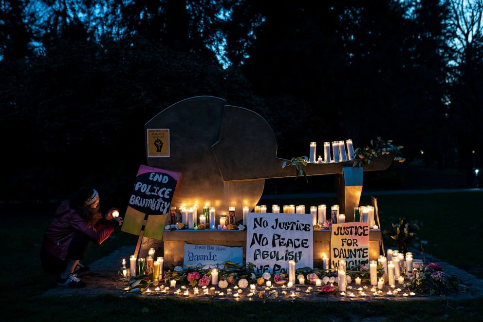 PHOTO: A person lights candles at a vigil for Daunte Wright in Portland, Oregon, on April 12, 2021.