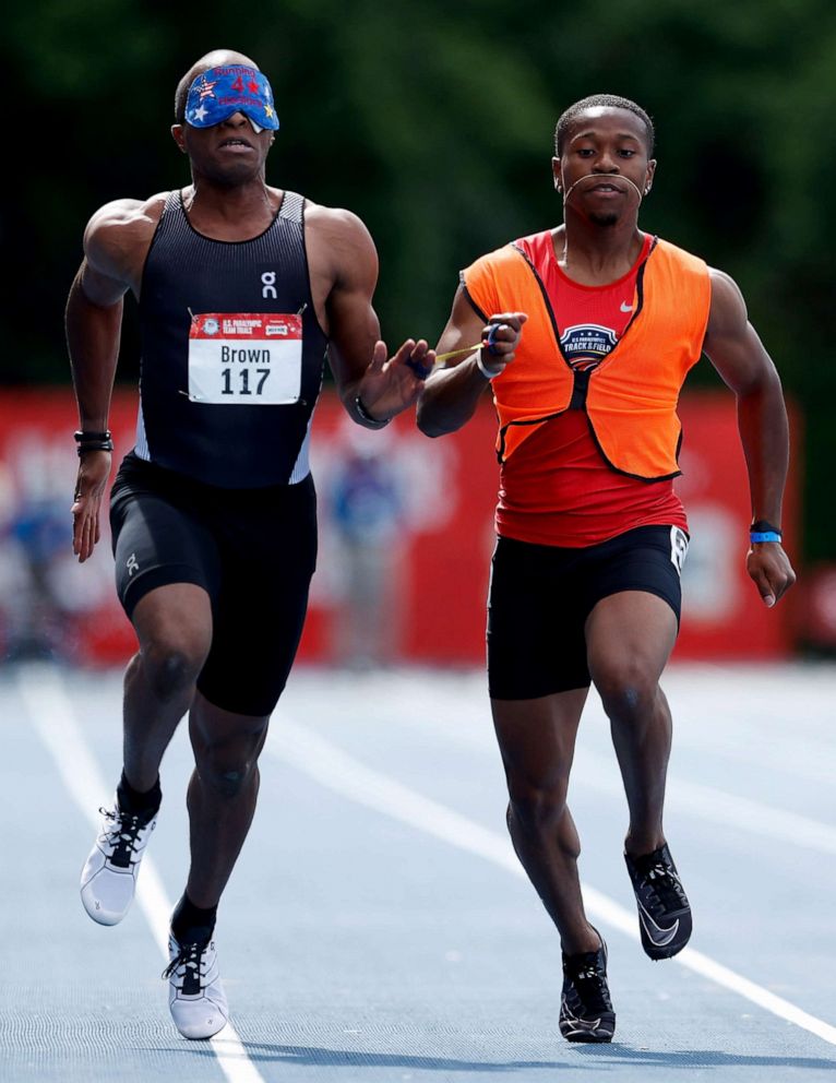 PHOTO: David Brown of the United States and guide Moray Stewart compete in the Men's 100 Meter Dash T11 Ambulatory final during the 2021 U.S. Paralympic Trials at Breck High School, June 19,  2021, in Minneapolis, Minnesota.