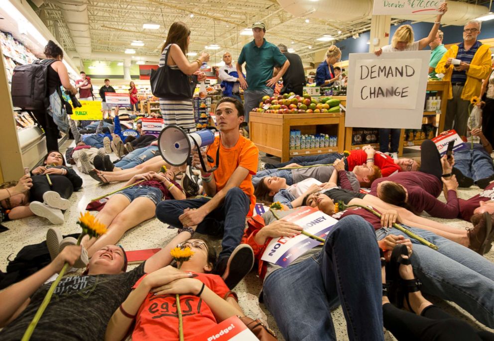 PHOTO: David Hogg, center, a student at Marjorie Stoneman Douglas High School along with other demonstrators lie on the floor at a Publix Supermarket in Coral Springs, Fla., May 25, 2018.