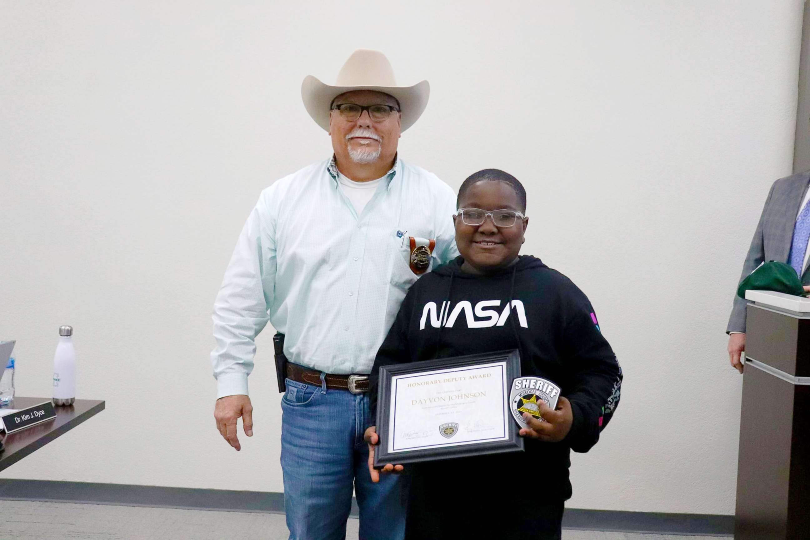 PHOTO: Sixth grader Davyon Johnson is honored by Undersheriff Greg Martin with a certificate naming him an honorary deputy for the County Sheriff's Office in Muskogee, Okla., Dec. 14, 2021.