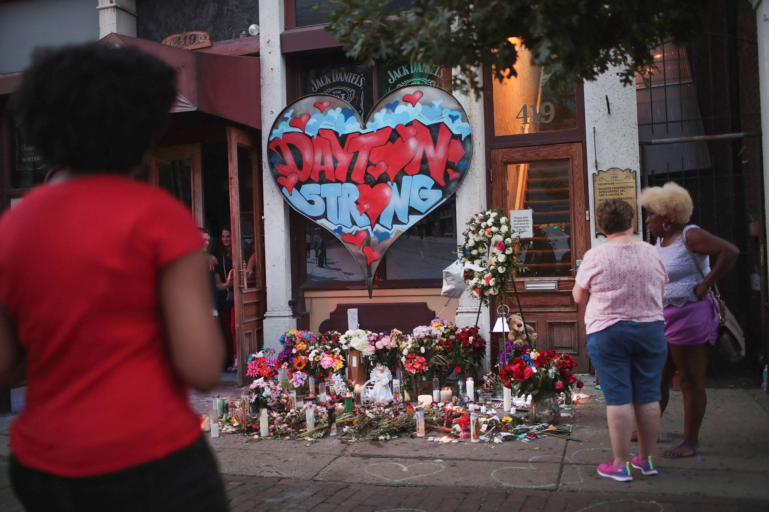 PHOTO: People congregate around a memorial to those killed in Sunday morning's mass shooting on Aug. 6, 2019 in Dayton, Ohio.