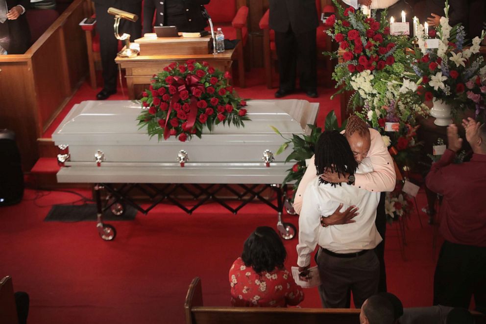 PHOTO: Dion Green is comforted by his uncle Randy Southhall during the funeral of his father Derrick Fudge at St. John Missionary Baptist Church on Aug. 10, 2019, in Springfield, Ohio.