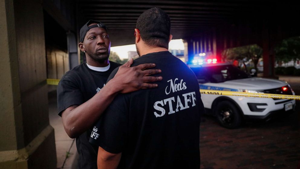 PHOTO: Witnesses comfort one another at the scene of a mass shooting, Sunday, Aug. 4, 2019, in Dayton, Ohio. 