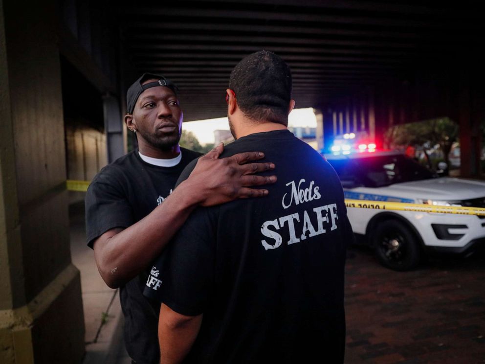 PHOTO: Witnesses comfort one another at the scene of a mass shooting, Sunday, Aug. 4, 2019, in Dayton, Ohio.