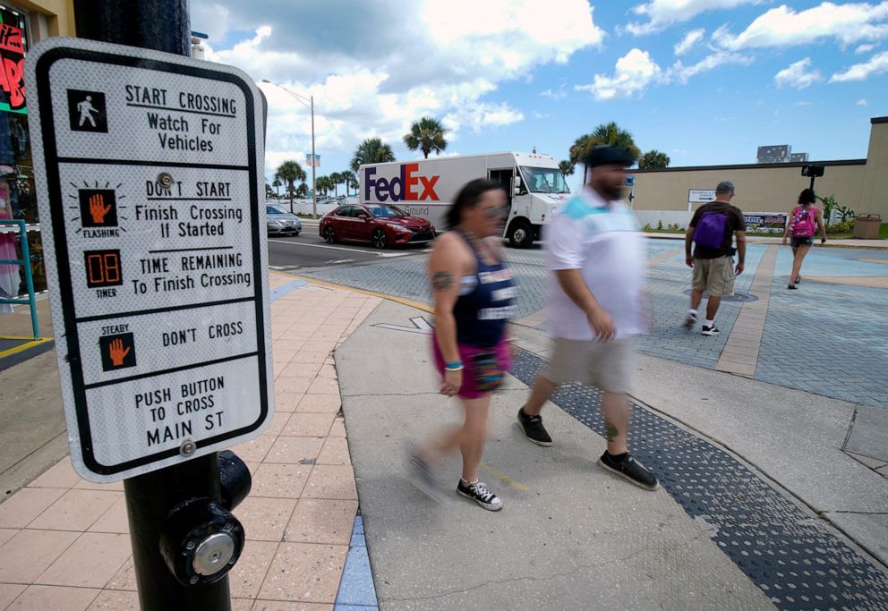 PHOTO: Two pedestrians cross State Road A1A while two others head across Main Street in Daytona Beach. The area sees a lot of tourists making their way around to see the sights, putting them in conflict with vehicles traveling through.
