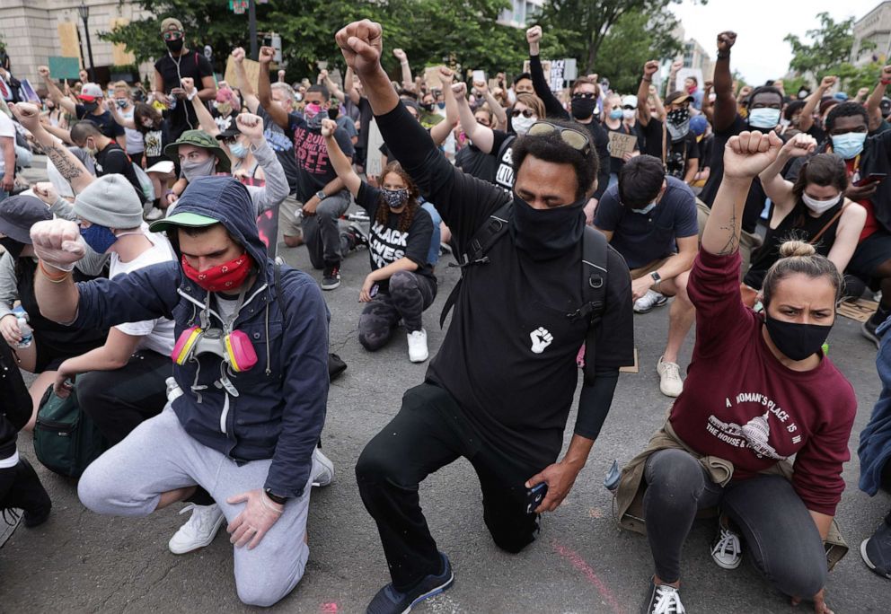 PHOTO: Demonstrators kneel and raise their fists during a protest against police brutality and the death of George Floyd, June 2, 2020 in Washington, D.C. 