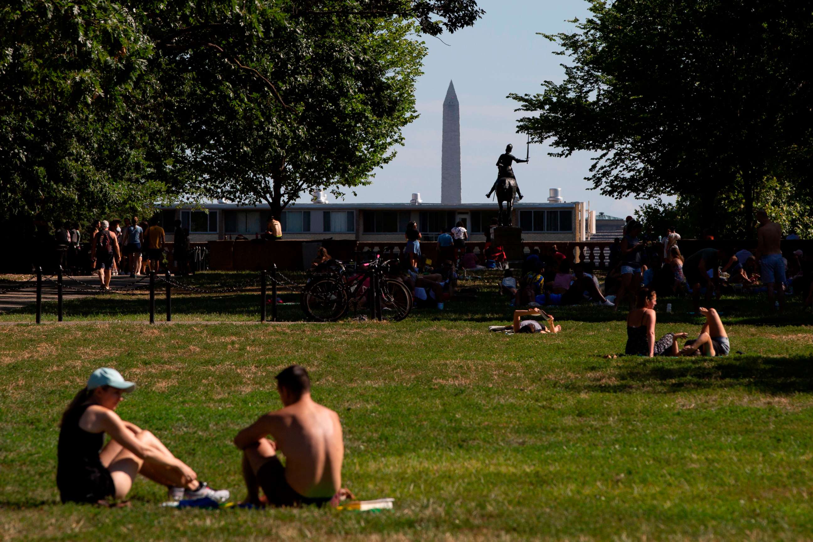 PHOTO: People relax at Meridian Hill Park on a summer day, with the Washington Monument in the distance, Aug. 11, 2019, in Washington, D.C.
