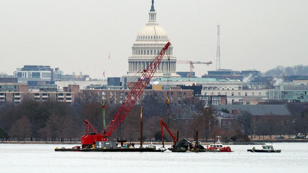 PHOTO: A salvage barge with a crane retrieves wreckage near the crash site of American Eagle Flight 5342 at Ronald Reagan Washington National Airport in Arlington, Virginia, Feb. 3, 2025.