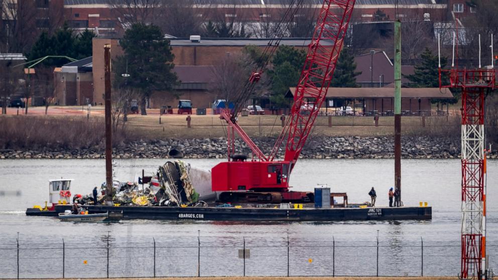 PHOTO: A salvage vessel carrying wreckage moves from the site in the Potomac River of a mid-air collision between an American Airlines jet and a Black Hawk helicopter, at Ronald Reagan Washington National Airport, Feb. 5, 2025, in Arlington, Va.