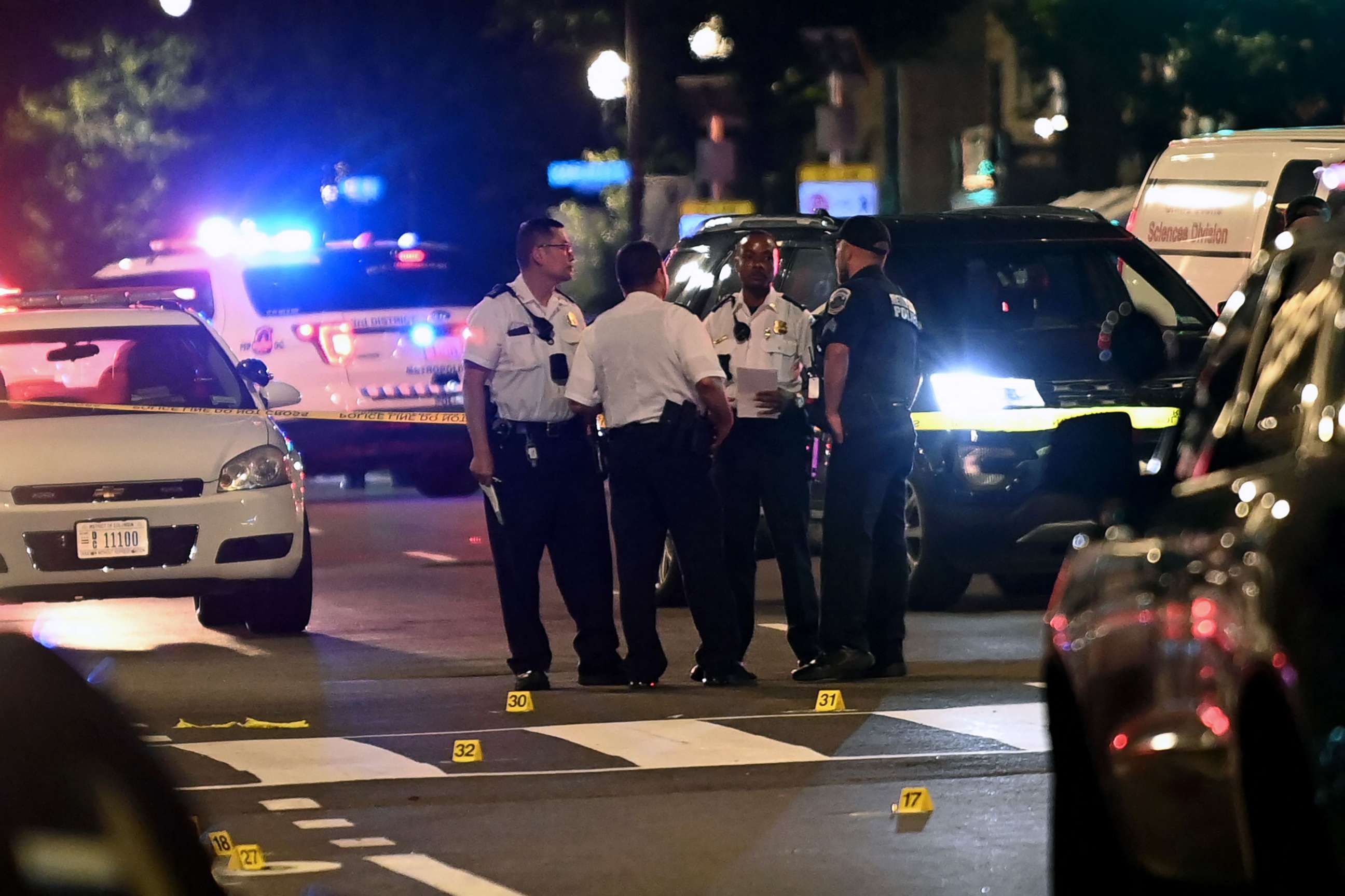 PHOTO: Police officers work at the scene of a shooting outside a restaurant in Washington, D.C., on July 22, 2021.