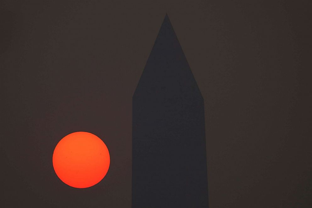 PHOTO: The sun rises behind the Washington Monument and a thick layer of smoke, June 8, 2023, in Washington, D.C.
