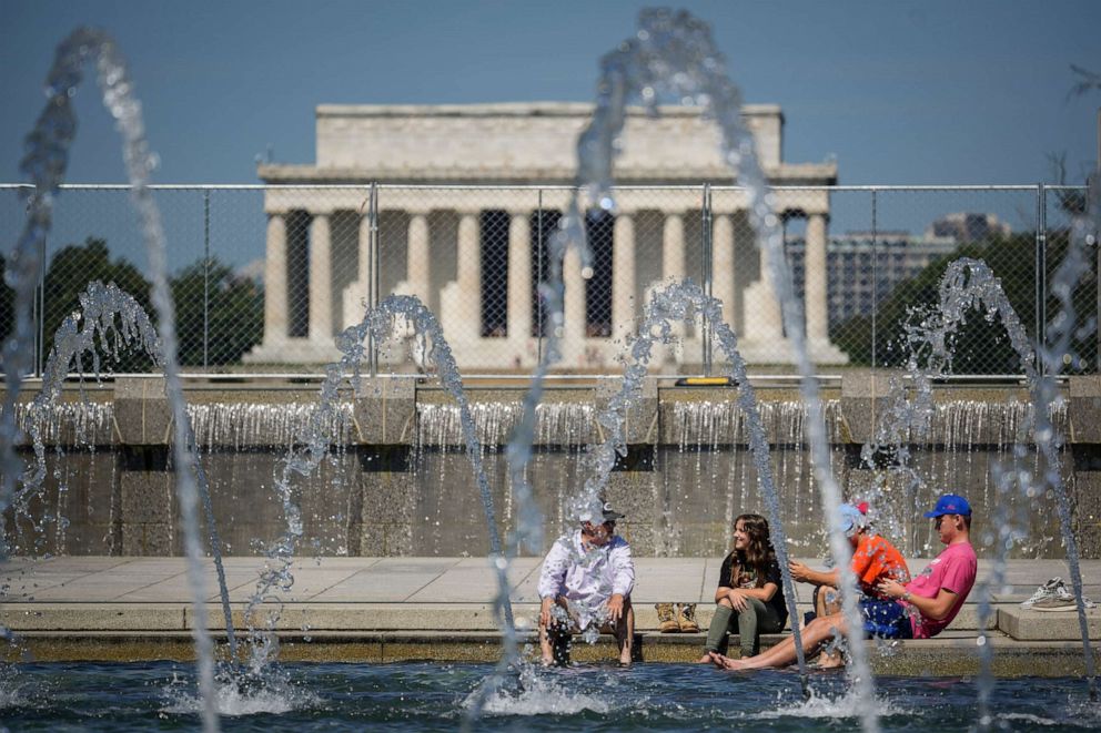 PHOTO: People cool off in the fountains at the World War II Memorial on the National Mall, June 29, 2021, in Washington, D.C.