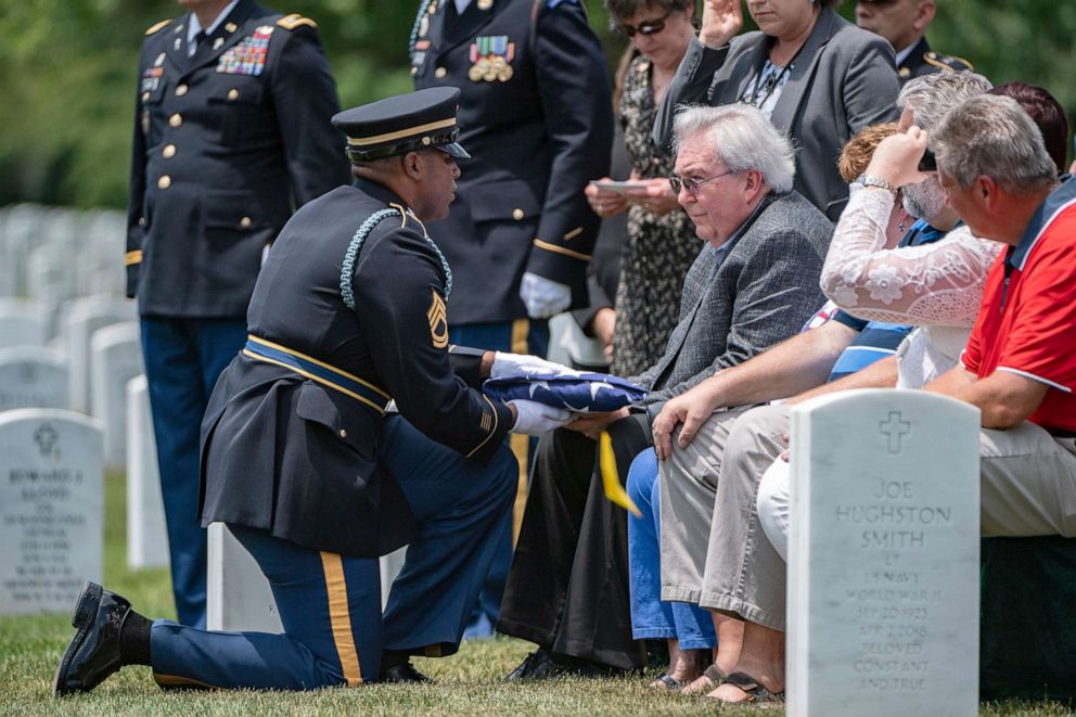PHOTO: The U.S. flag is presented to Carl W. Mann II during his father, U.S. Army Sgt. Carl Mann's, funeral in Section 59 of Arlington National Cemetery, Arlington, Virginia, June 6, 2019.