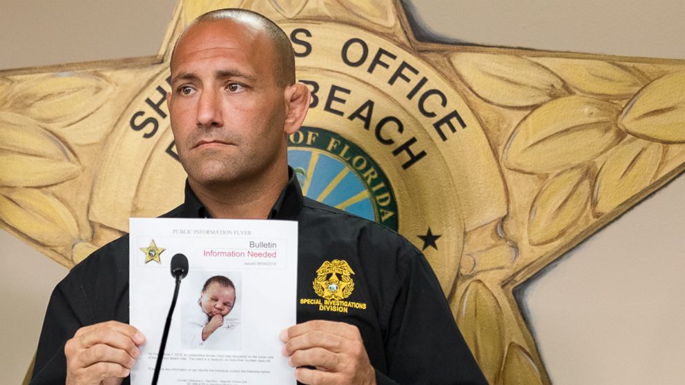 Special Investigations Unit Captain Steven Strivelli holds up an artist's sketch of a baby found floating on the ocean side of the Boynton Beach Inlet, in West Palm Beach, Fla., June 4, 2018.