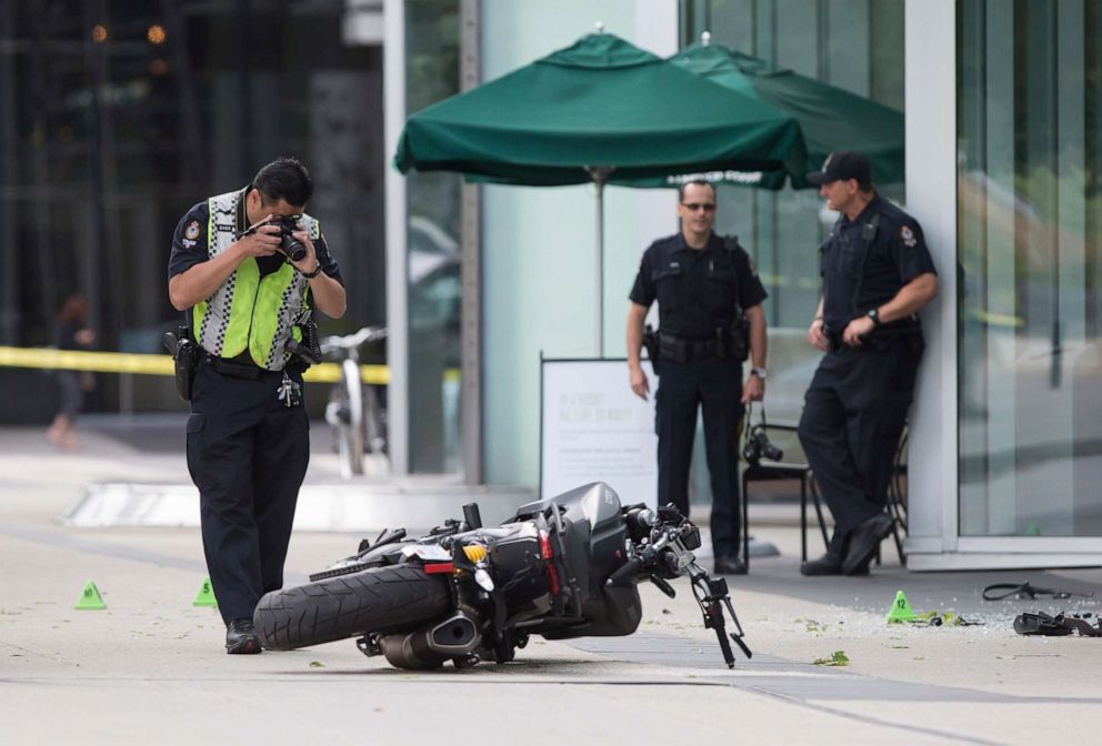PHOTO: A police officer photographs a motorcycle after stunt driver Joi "S.J." Harris, while working on the movie "Deadpool 2," died after a crash on set, in Vancouver, B.C., Aug. 14, 2017.