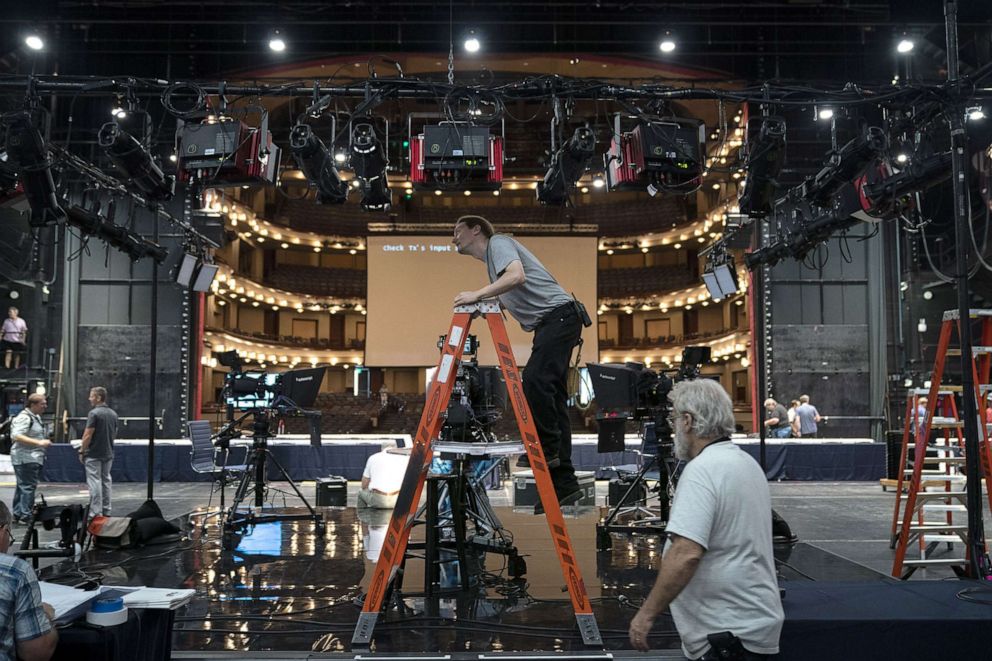 PHOTO: Workers assemble the television set inside the media filing center at Adrienne Arsht Center for the Performing Arts where the first Democratic presidential primary debates for the 2020 elections will take place, June 25, 2019 in Miami.