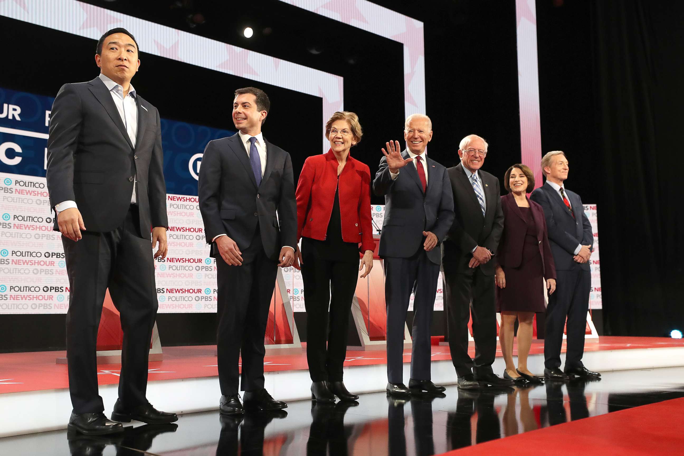 PHOTO: Democratic presidential candidates Andrew Yang, South Bend, Indiana Mayor Pete Buttigieg, Sen. Elizabeth Warren, Joe Biden, Sen. Bernie Sanders, Sen. Amy Klobuchar, and Tom Steyer await the start of the Democratic presidential primary debate.