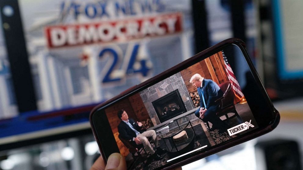 PHOTO: This photo shows a preview of Tucker Carlson's interview of former US President Donald Trump on the same night of the first Republican Presidential primary debate in Milwaukee, Wisconsin, on a smartphone ahead of the debate on Aug. 23, 2023