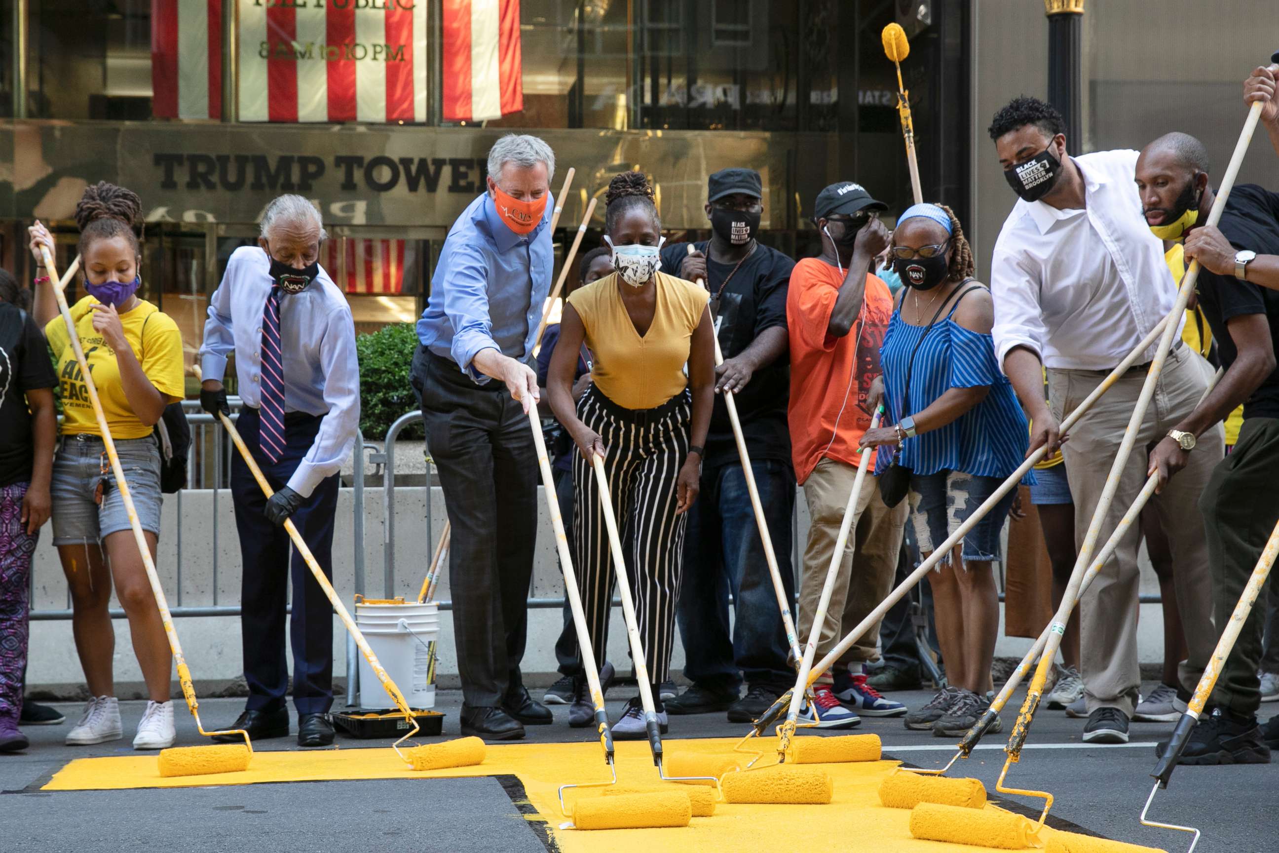 PHOTO: Mayor Bill de Blasio, third from left, participates in painting Black Lives Matter on Fifth Avenue in front of Trump Tower, July 9, 2020, in New York.