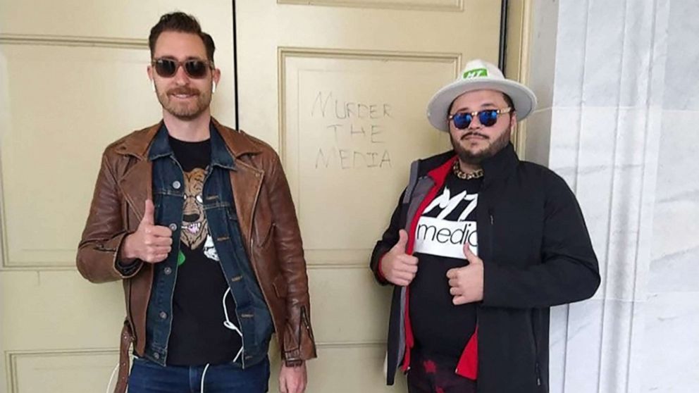 PHOTO: Nicholas DeCarlo and Nicholas Ochs pose next to a carving that says "murder the media" during the insurrection at the Capitol, Jan. 6, 2021, in an image released by the U.S. Attorney’s Office of the District of Columbia.