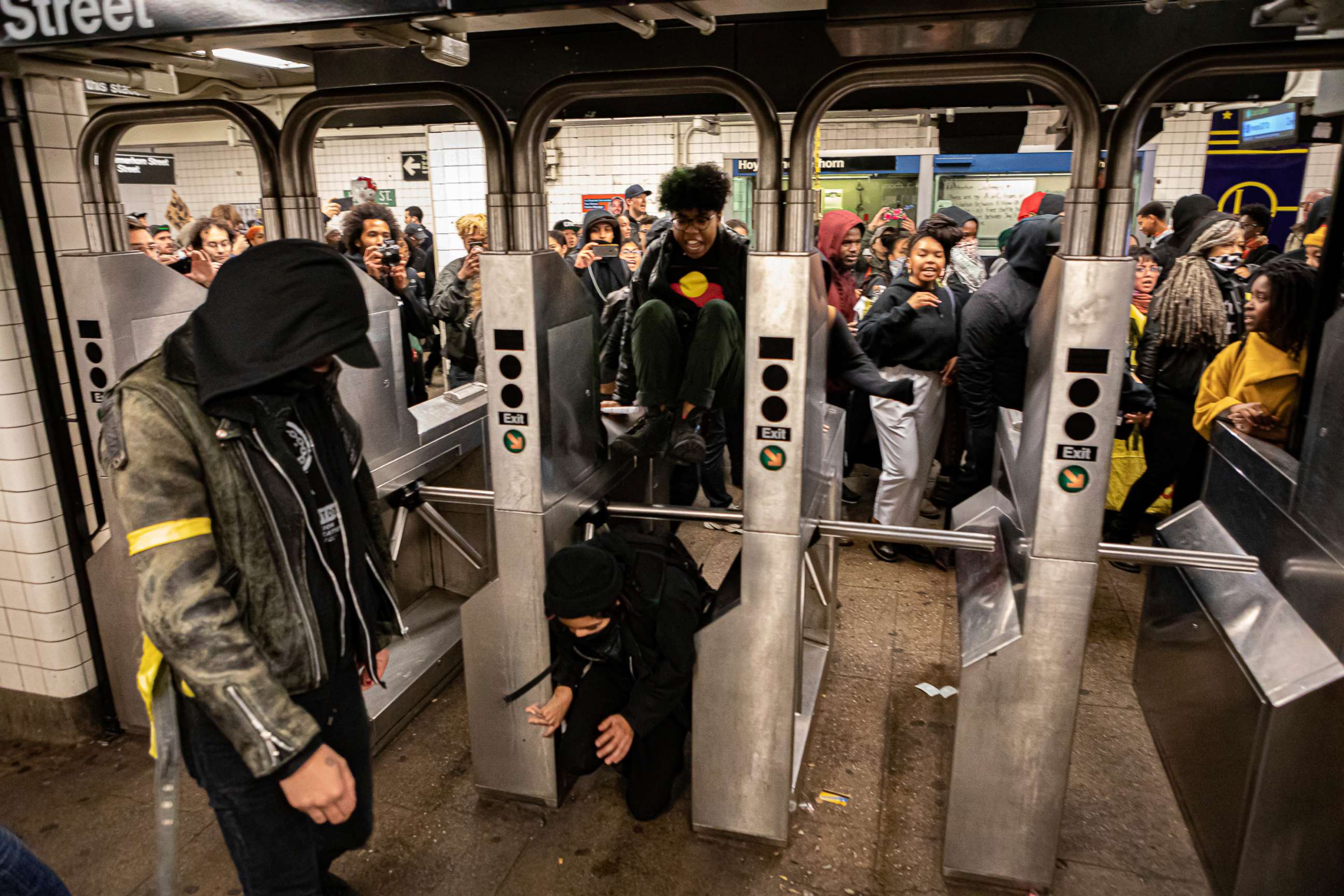 PHOTO: People pass through a subway station in Brooklyn, New York, during a protest against the New York City Police department organized by the activist group Decolonize This Place, Nov. 2, 2019.