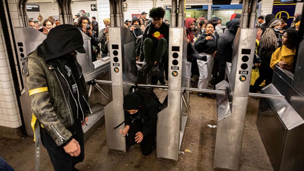 PHOTO: People pass through a subway station in Brooklyn, New York, during a protest against the New York City Police department organized by the activist group Decolonize This Place, Nov. 2, 2019.