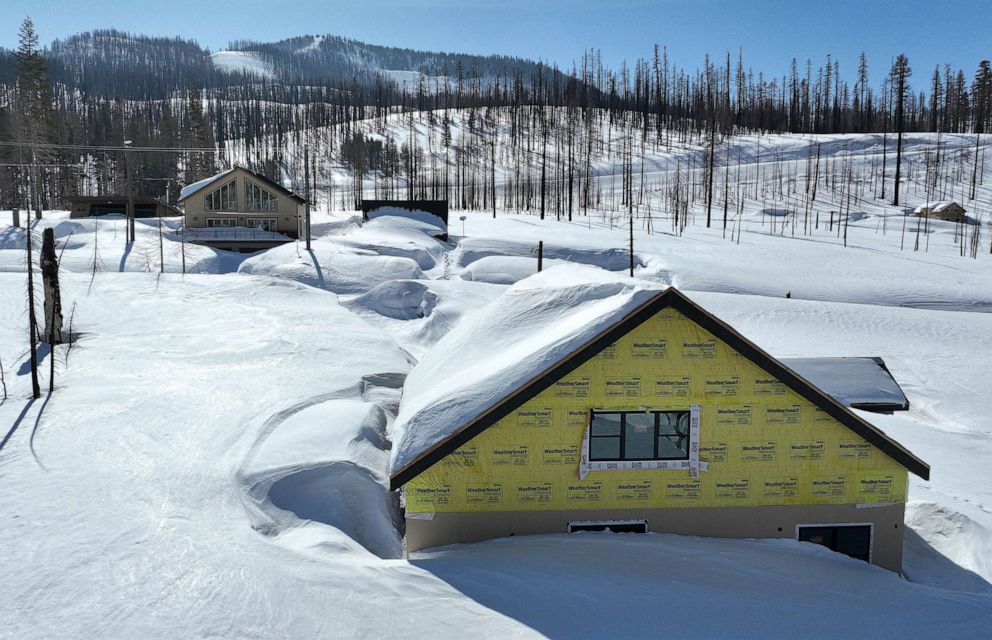 PHOTO: In an aerial view, a home is seen covered in snow on March 3, 2023, in Twin Bridges, Calif.