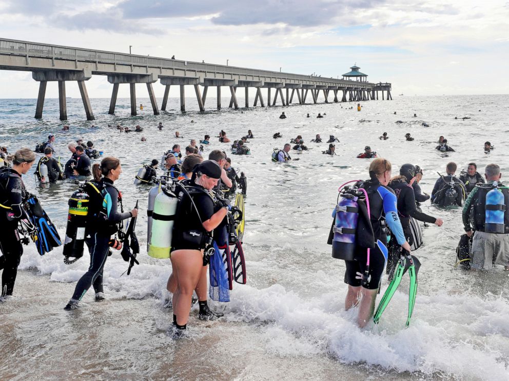 PHOTO: Divers enter the water in an attempt to break the world record for the largest underwater cleanup at the Deerfield Beach International Fishing Pier in Deerfield Beach, Fla., Saturday, June 15, 2019.