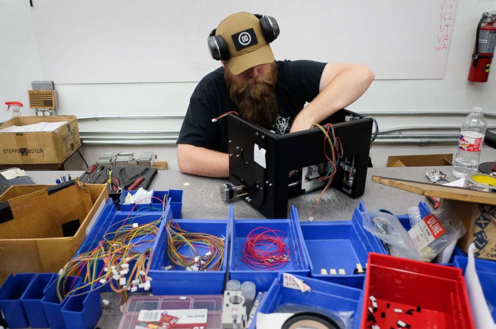 PHOTO: J.C. Cotter installs an electronic package for a Ghost Gunner milling machine at the Defense Distributed factory in Austin, Texas, Aug. 1, 2018.