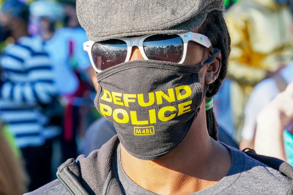 PHOTO: A protester wears a face mask written on Defund Police during a Black Trans Lives Matter rally in Hudson River Park in New York, Sept. 19, 2020.